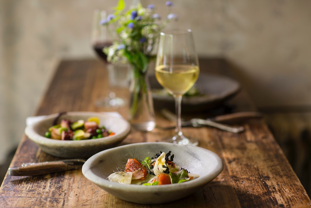 At home date-night ideas: Romantic dinner for two, with your favorite takeout | Photo by Stefan Johnson via Unsplash