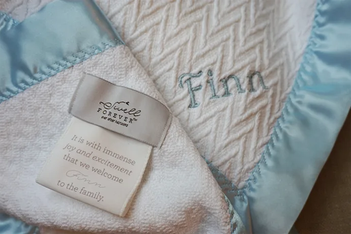 Thoughtful gifts for adoptive parents: A Swell Forever baby blanket with a custom message