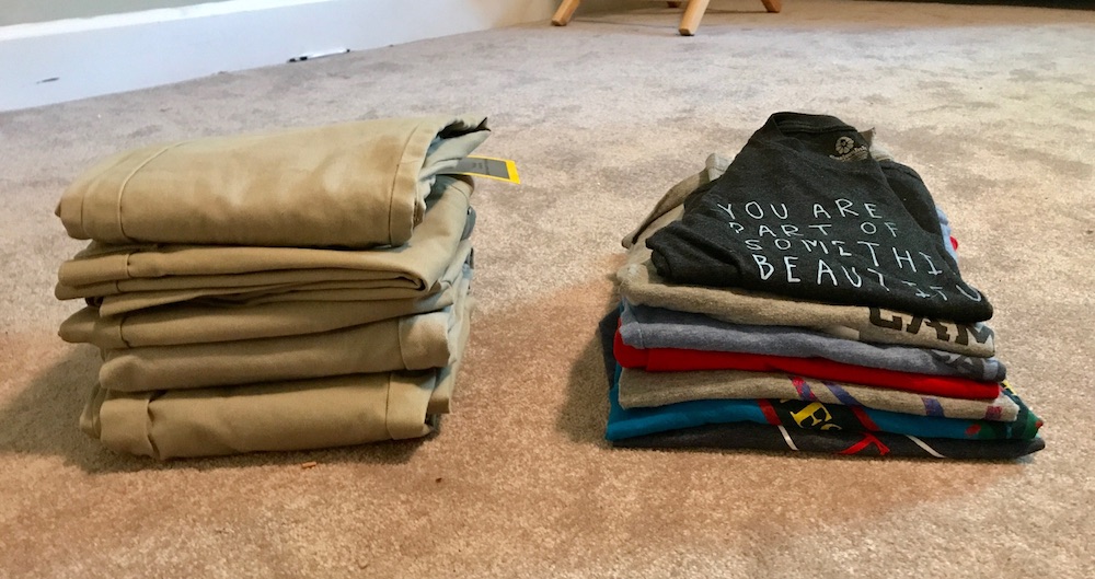 How to make a capsule wardrobe for kids: Piles of clothes, after paring down.