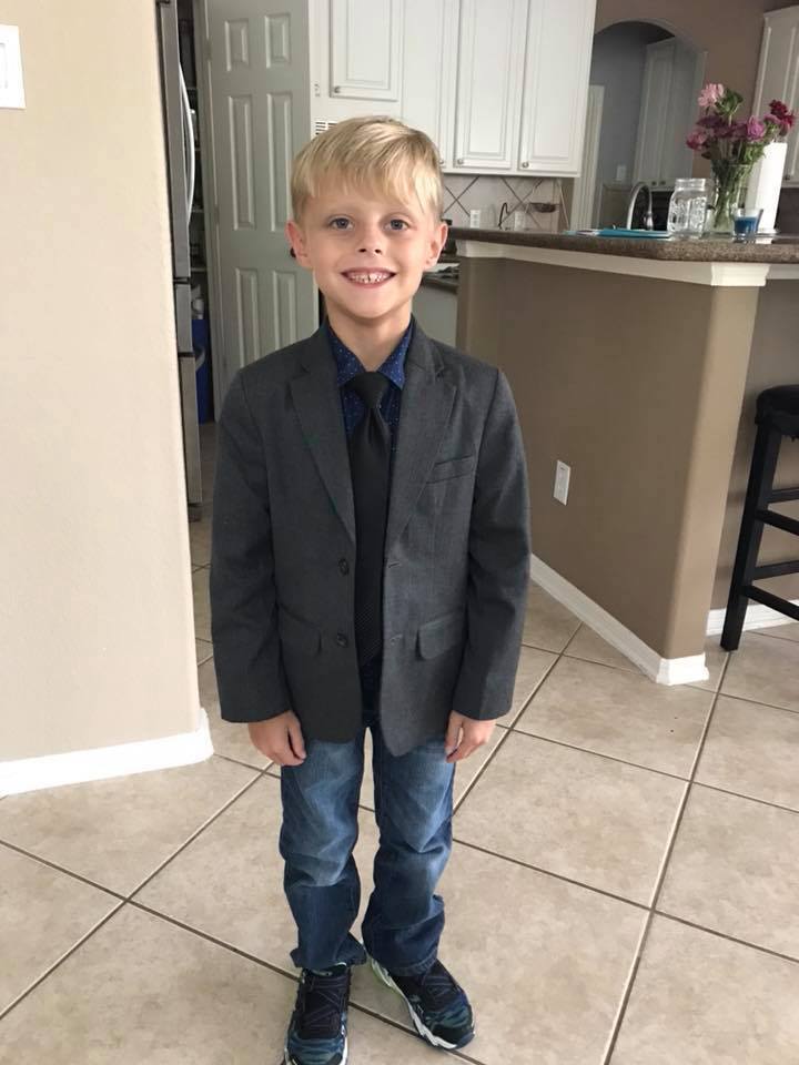 Noah Speck in his coat and tie for school, before Michael Strahan's act of kindness