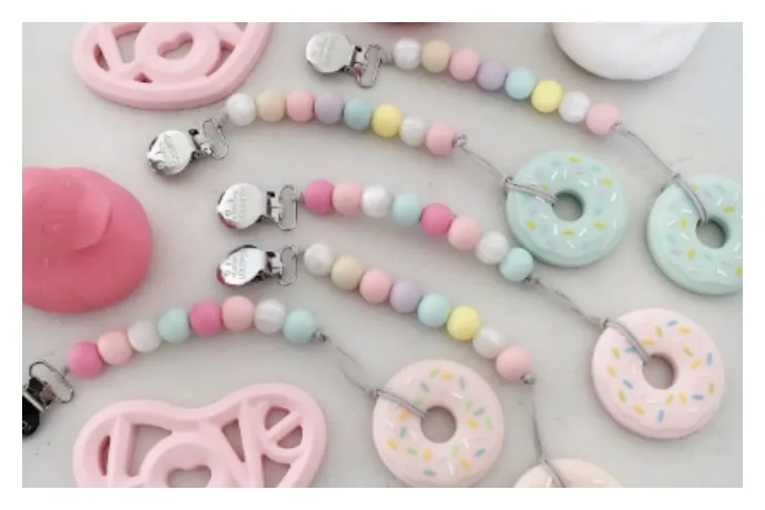 Spearmint Love silicone teethers and paci clips