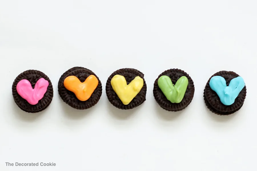 DIY Valentine's gifts kids can make, like these mini Oreos with hearts at The Decorated Cookie.