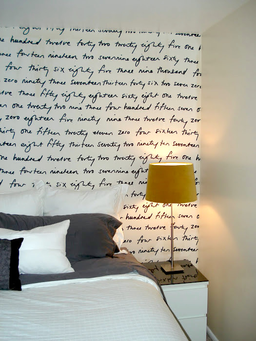 How to hang fabric instead of wallpaper: Graphic fabric behind a bed at Numbered Street Designs blog