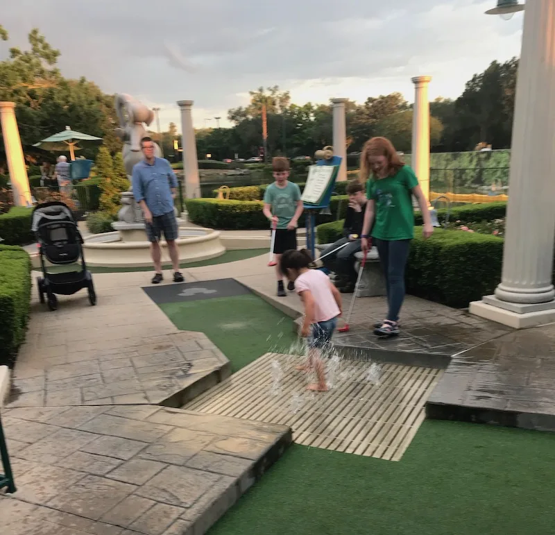 Disney World with kids with special needs: Pack extra clothes for stress-free moments of unplanned fun, like smashing in the water on the putt putt course!